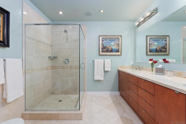 bathroom featuring walk in shower, vanity, and tile patterned flooring