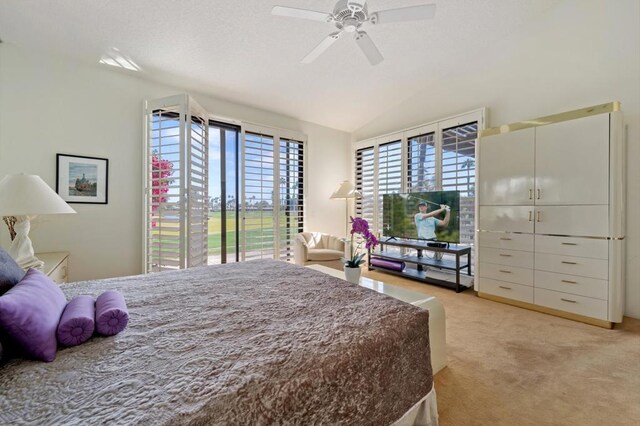 carpeted bedroom with ceiling fan and vaulted ceiling