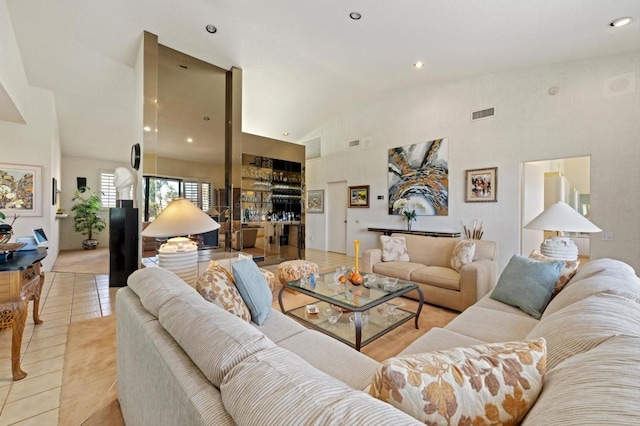 tiled living room featuring high vaulted ceiling