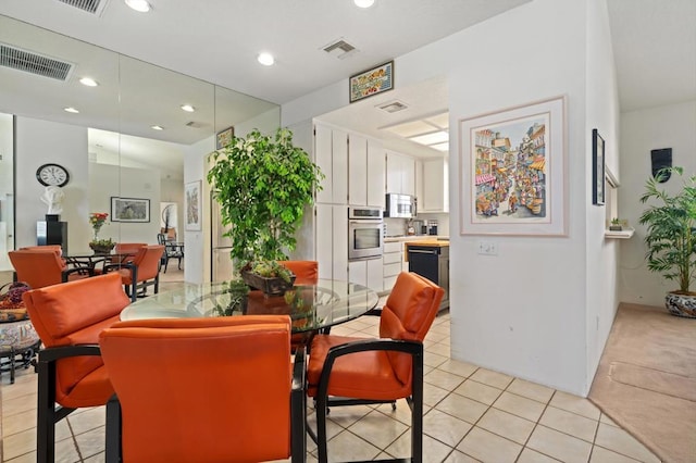 dining area featuring light tile patterned flooring