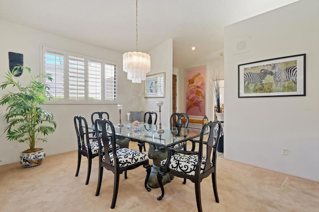 dining area with lofted ceiling, light carpet, and a notable chandelier