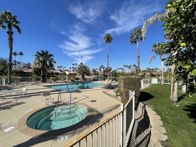 view of swimming pool with a water view, a patio area, and a community hot tub