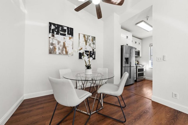 dining area with dark wood-type flooring and ceiling fan