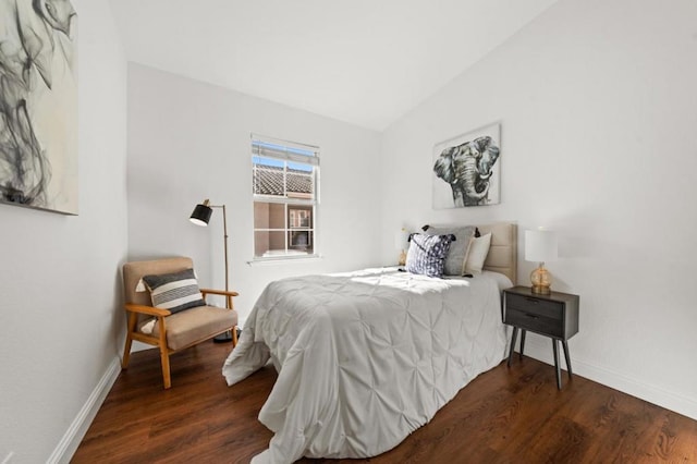 bedroom featuring lofted ceiling and dark hardwood / wood-style flooring