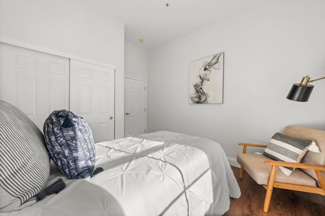 bedroom with a closet and hardwood / wood-style flooring