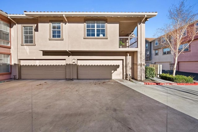 view of front facade featuring a balcony and a garage