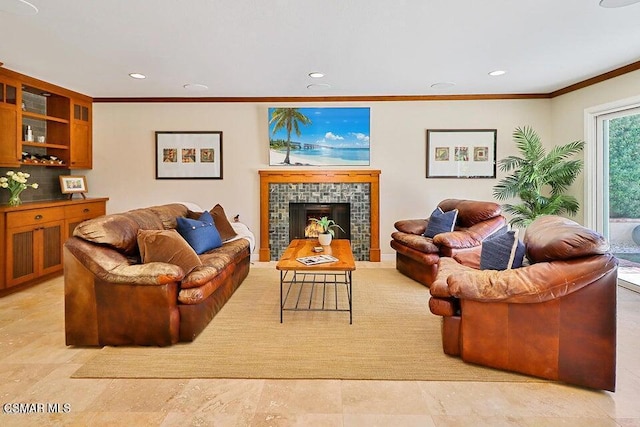 living room with a tile fireplace and ornamental molding