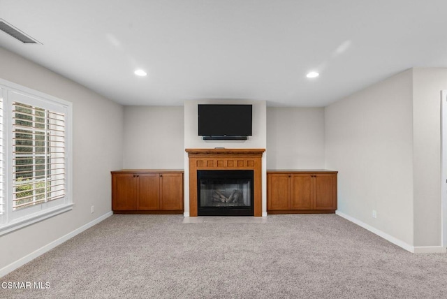 unfurnished living room with light carpet