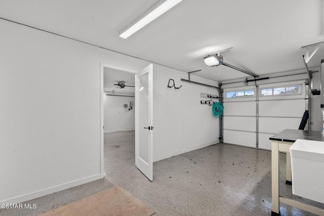 garage featuring sink and a garage door opener