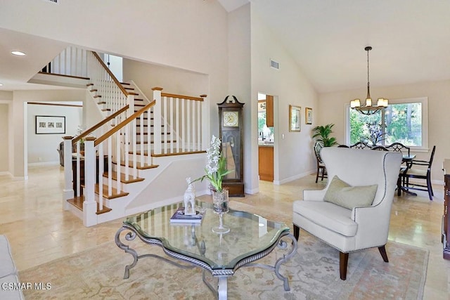 living room with high vaulted ceiling and a notable chandelier