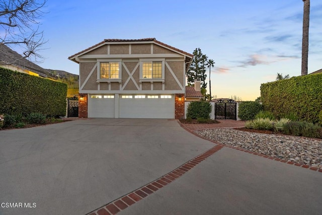 tudor house featuring a garage