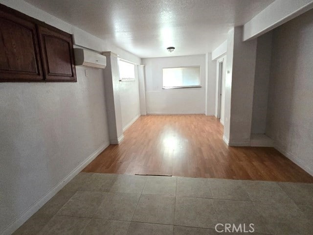 corridor featuring a wall unit AC