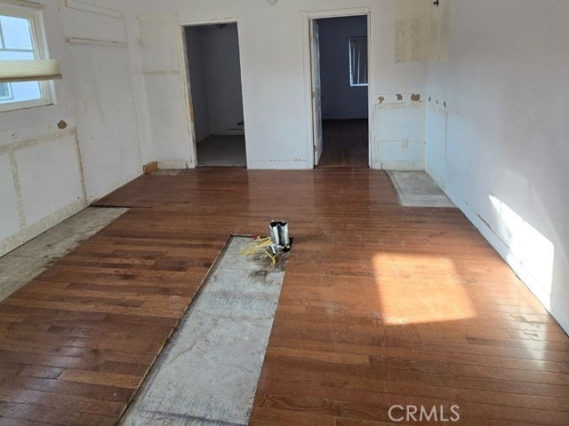 unfurnished room with dark hardwood / wood-style flooring