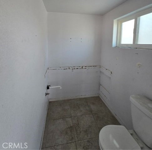 bathroom featuring tile patterned floors and toilet