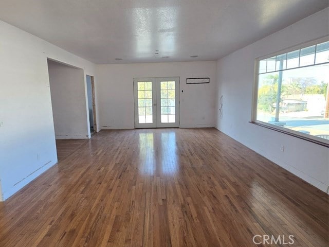 empty room featuring french doors and hardwood / wood-style flooring