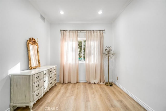 unfurnished room with crown molding and light hardwood / wood-style flooring