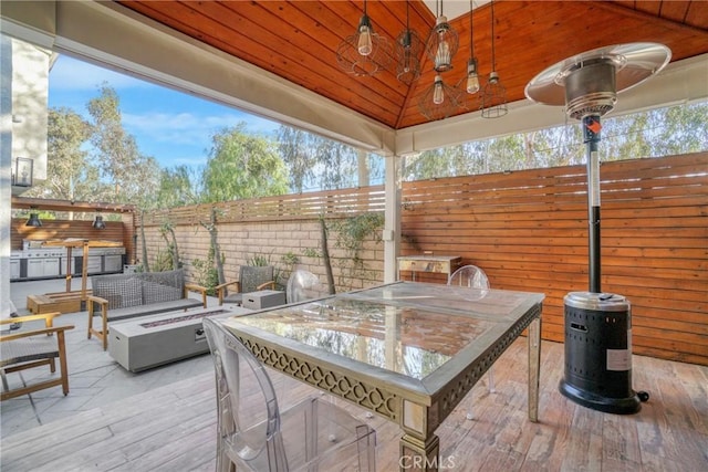 view of patio featuring ceiling fan, an outdoor fire pit, and a gazebo