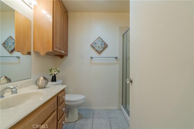 bathroom with toilet, vanity, tile patterned floors, and walk in shower