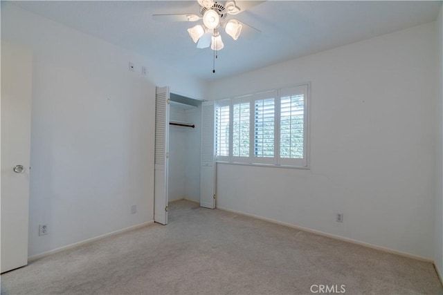 unfurnished bedroom with light carpet, a closet, and ceiling fan