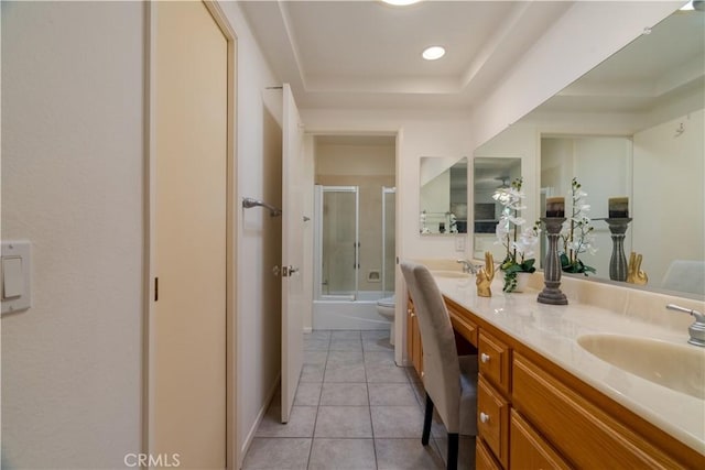 full bathroom with enclosed tub / shower combo, vanity, a tray ceiling, tile patterned floors, and toilet