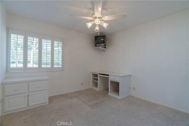 interior space with ceiling fan and light colored carpet