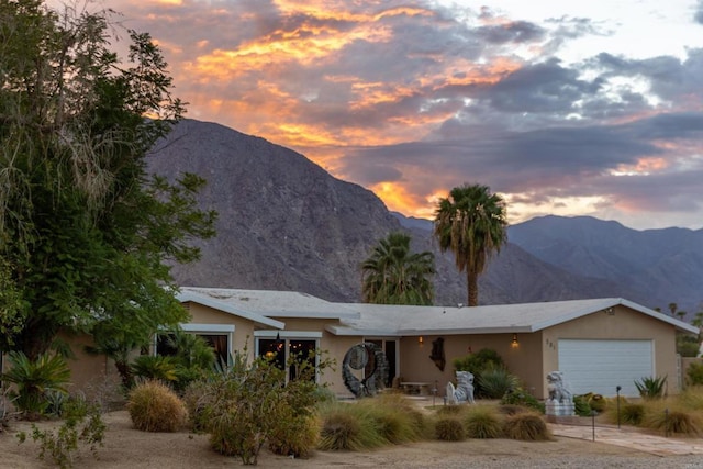 view of front facade featuring a garage and a mountain view