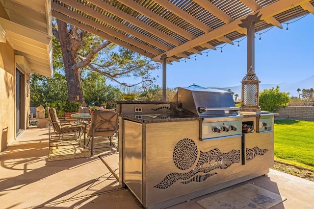 view of patio / terrace featuring a pergola, a grill, and an outdoor kitchen