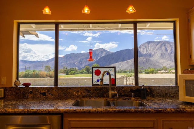 kitchen featuring decorative light fixtures, plenty of natural light, sink, and a mountain view