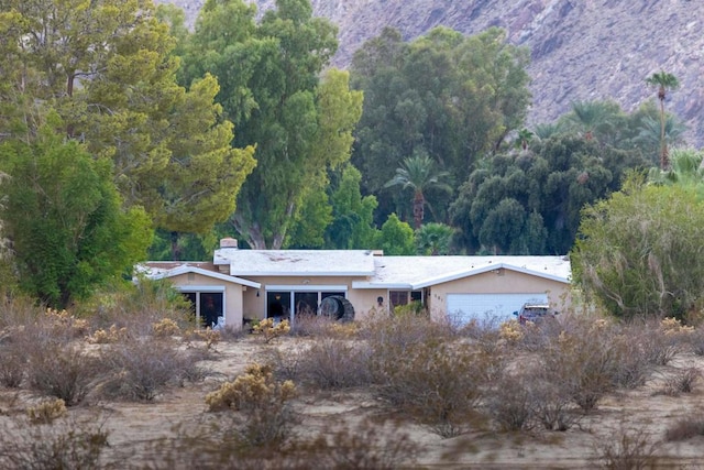 exterior space featuring a mountain view and a garage