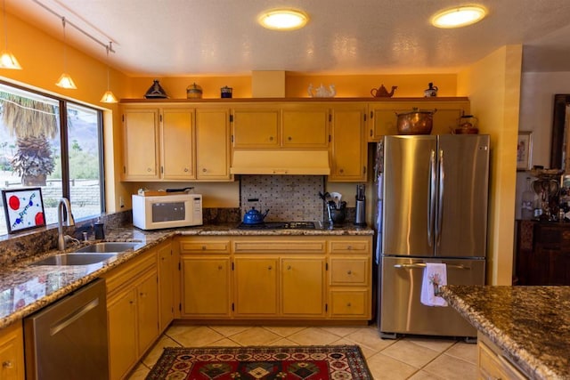 kitchen with sink, light tile patterned floors, stainless steel appliances, and track lighting