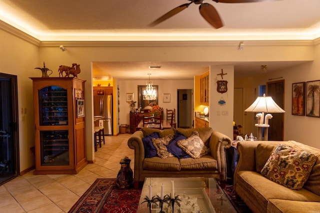 living room with light tile patterned floors, crown molding, and ceiling fan with notable chandelier