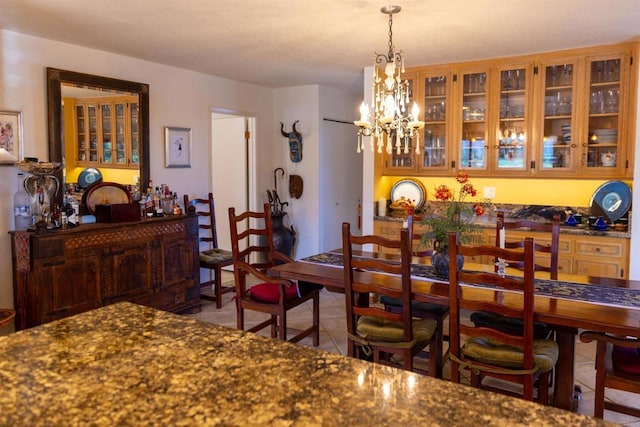 dining room featuring tile patterned floors and an inviting chandelier