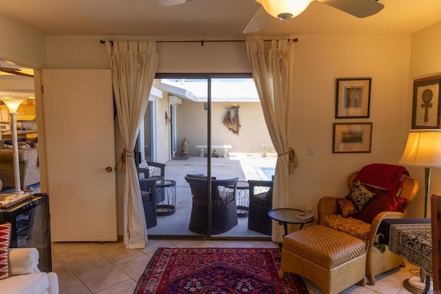 sitting room featuring ceiling fan and light tile patterned flooring