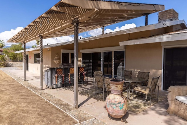 view of patio / terrace with exterior bar and a pergola