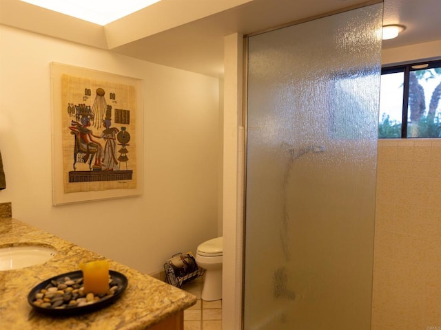 bathroom featuring toilet, tile patterned flooring, an enclosed shower, and vanity