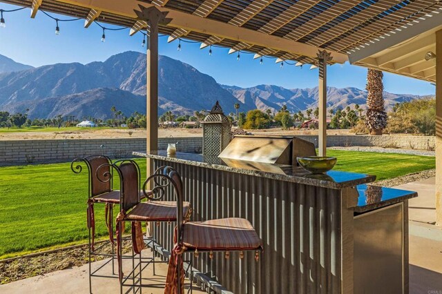 view of patio / terrace with a mountain view and area for grilling