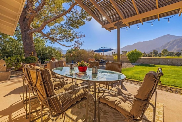 view of patio / terrace with a pergola and a mountain view