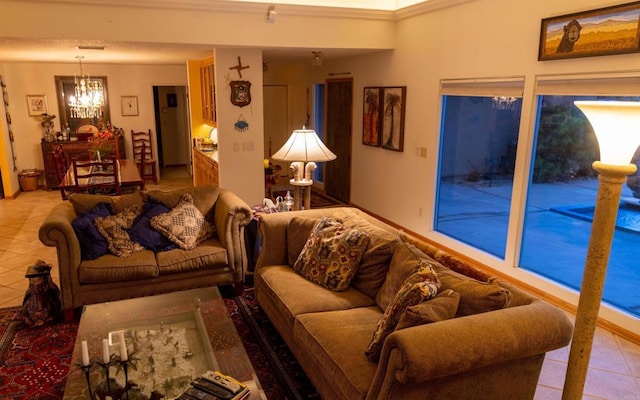 living room with an inviting chandelier, light tile patterned flooring, and ornamental molding