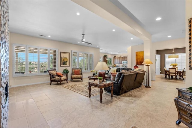 tiled living room with ceiling fan