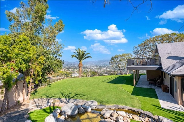 view of yard with a mountain view and a patio