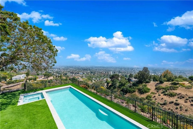 view of pool with a yard