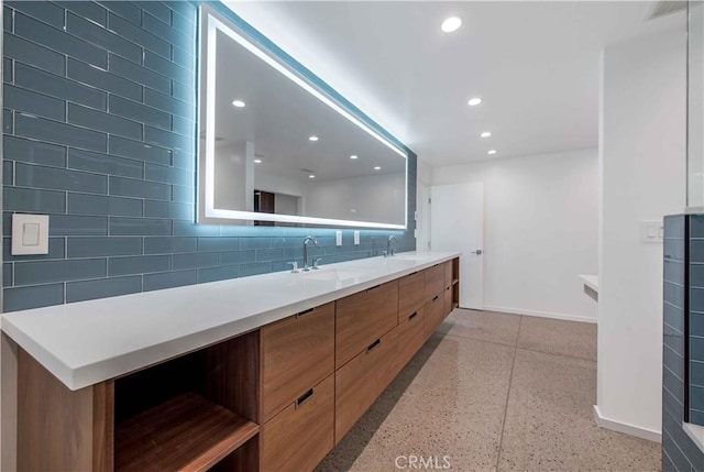 bathroom featuring decorative backsplash and vanity