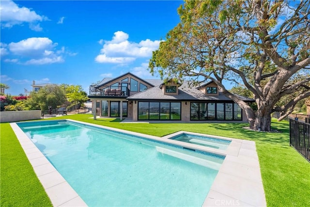 view of swimming pool featuring an in ground hot tub and a yard