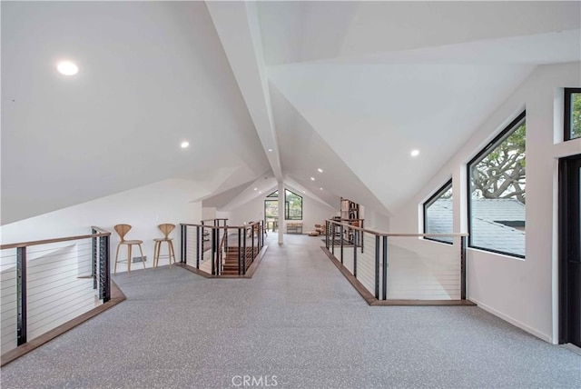 bonus room with light colored carpet and lofted ceiling