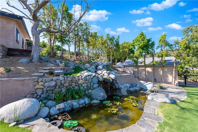 view of yard with a garden pond