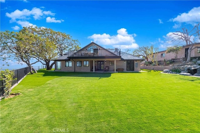 rear view of property featuring a yard