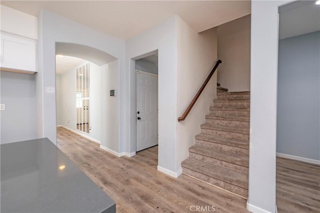 staircase featuring wood-type flooring