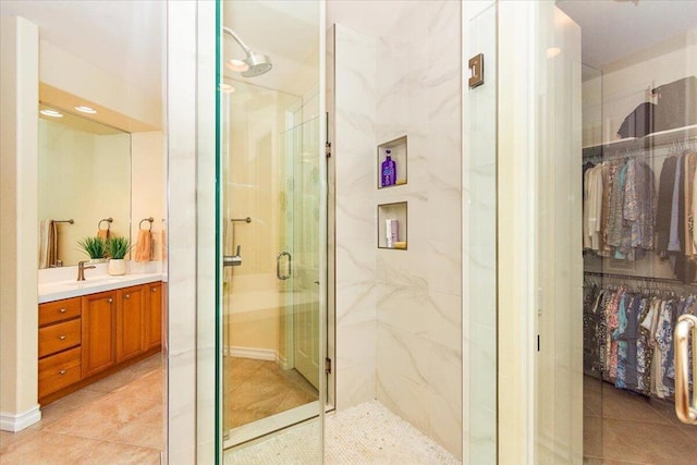 bathroom featuring vanity, tile patterned flooring, and an enclosed shower