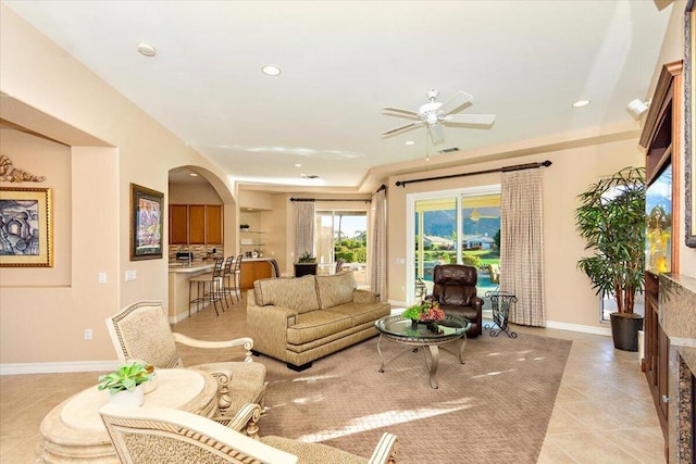 living room with ceiling fan and light tile patterned floors