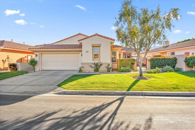 mediterranean / spanish home featuring a front lawn and a garage